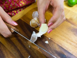 Garlic being peeled for som tam salad