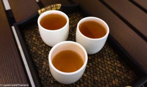 Three cups of hot tea on a tray