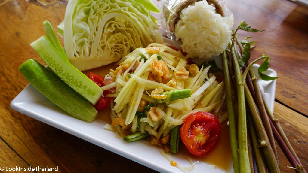 Som Tam Thai papaya salad with cucumber, cabbage and sticky rice on the side