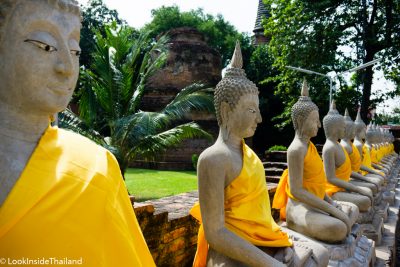 Buddhas lined up in a roll in a temple in Ayutthaya Thailand