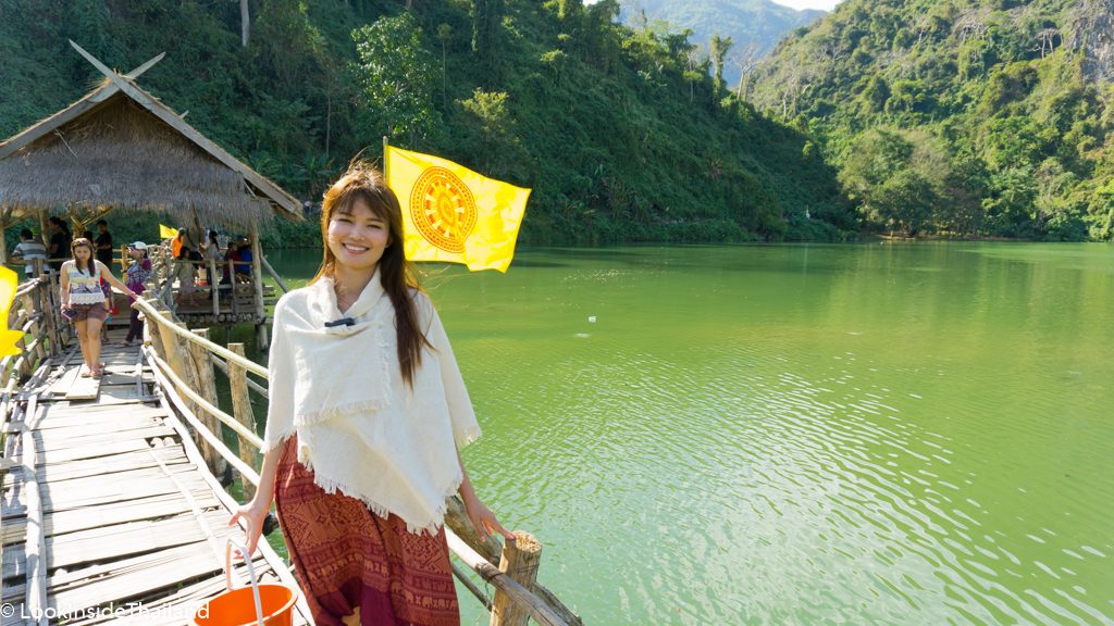 Green emerald lake with wooden bridge