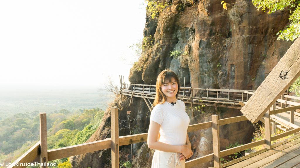 Namfon on a wooden bridge connected to the side of am mountain in Thailand